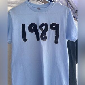 1989 Light Blue Tee Shirt. Size Adult Small. Never Worn. NWOT.